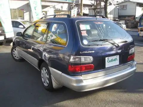 カタログ画像：カローラツーリングワゴン （COROLLA TOURING WAGON） Ｌツーリング スポーツルックパッケージ 1998年4月 GF-AE100G 1500cc ブルーラディアンストーニング 燃費14.6km / l バック