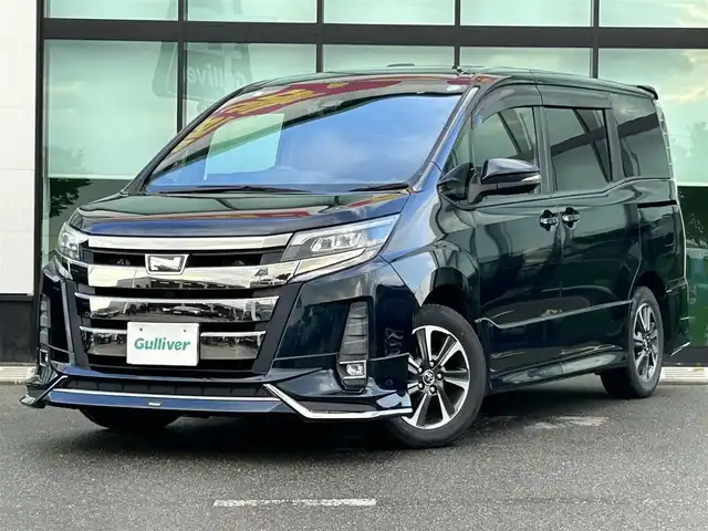 トヨタ ノア Si 和歌山県 2017(平29)年 6.8万km ブラッキッシュアゲハガラスフレーク ALPINE10インチナビ/フルセグTV/Bluetooth/CD/DVD/USB/バックカメラ/ETC/ドライブレコーダー/衝突軽減カメラ/車線逸脱防止機能/クルーズコントロール/サンルーフ/両側パワースライドドア/モデリスタエアロ/革巻きステアリング/ステアリングスイッチ/LEDヘッドライト/フォグランプ/オートライト/オートハイビーム/アイドリングストップ/純正16インチAW/ドアバイザー/プッシュスタート/スマートキー