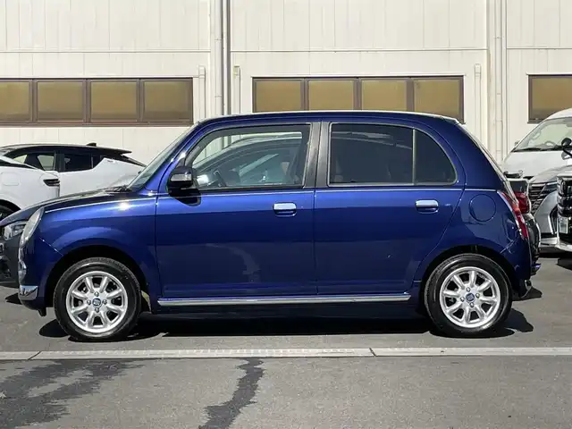 ダイハツ ミラ ジーノ プレミアムL 群馬県 2007(平19)年 3.3万km プレシャスブルーマイカメタリック ７インチＳＤナビ　/フルセグ　/Ｂｌｕｅｔｏｏｔｈ　/ＣＤ・ＤＶＤ　/ＥＴＣ　/木目調＋本革ステアリング　/木目調内装　/純正フロアマット　/電動格納ミラー　/１４インチアルミホイール　/リモコンキー　/パワーウィンドウ