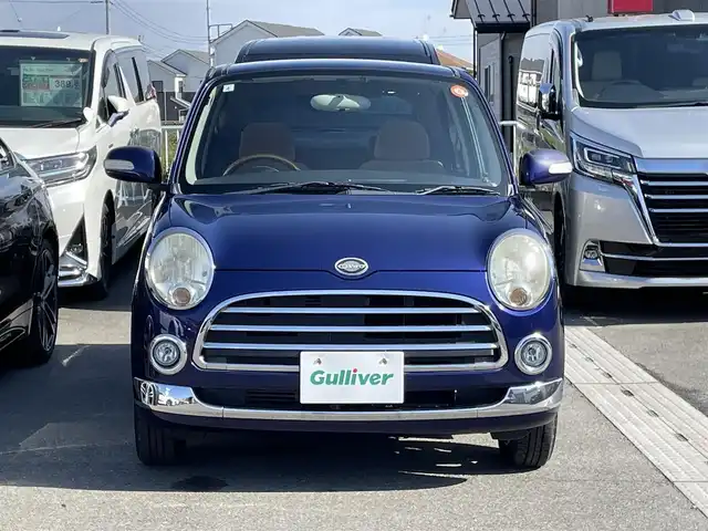 ダイハツ ミラ ジーノ プレミアムL 群馬県 2007(平19)年 3.3万km プレシャスブルーマイカメタリック ７インチＳＤナビ　/フルセグ　/Ｂｌｕｅｔｏｏｔｈ　/ＣＤ・ＤＶＤ　/ＥＴＣ　/木目調＋本革ステアリング　/木目調内装　/純正フロアマット　/電動格納ミラー　/１４インチアルミホイール　/リモコンキー　/パワーウィンドウ