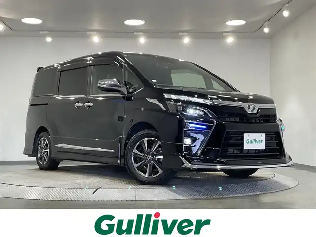 トヨタ ヴォクシー ZS 煌Ⅱ 愛知県 2019(令1)年 5.6万km ブラック アルパインＢＩＧＸ１１インチナビ/モデリスタエアロ/両側パワースライドドア/衝突軽減ブレーキ/車線逸脱警報/クリアランスソナー/先行車発進告知/オートハイビーム/クルーズコントロール/バックカメラ/ビルトインＥＴＣ/USB＆HDMI入力端子/ＬＥＤヘッドライト/アイドリングストップ/シートカバー/エムズスピードフロアマット/純正16インチアルミホイール