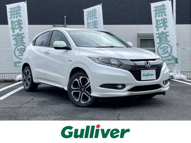 ホンダ ヴェゼル ハイブリッド Z 三重県 2015(平27)年 7.9万km ホワイトオーキッドパール 登録時78211km/禁煙車/ワンオーナー/ハーフレザーシート/ルーフレール/純正ナビ/（AM/FM/TV/Bluetooth/HDMI）/ワンセグTV/バックカメラ/ビルトインETC/ステアリングスイッチ/パドルシフト/クルーズコントロール/オートライト/スペアキー/プッシュスタート