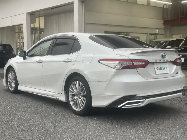 トヨタ カムリ G レザーパッケージ 千葉県 2018(平30)年 9.9万km プラチナホワイトパールマイカ モデリスタエアロ（フロント・サイド・リア）/純正ナビ【フルセグ、BT、CD、USB、AUX、SD】/純正18インチアルミホイール/プリクラッシュセーフティ/パーキングアシスト/ブラインドスポットモニター/リヤクロストラフィックアラート/インテリジェントクリアランスソナー/ヘッドアップディスプレイ/ビルトインETC2.0/クルーズコントロール/MT付AT/オートライト/オートハイビーム/前席パワーシート/前席シートヒーター/電動パーキングブレーキ/前ドラレコ（DRY-ST3000）/デュアルエアコン/フルオートPW/純正フロアマット/ドアバイザー