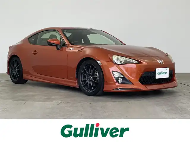 トヨタ ８６ GT 大分県 2012(平24)年 8.4万km オレンジメタリック 社外メモリーナビ/ (BT/CD/DVD/AM/FM)/プッシュスタート/ETC/革巻きステアリング/パドルシフト/純正フロアマット/電動格納ミラー/社外エアロ/ (フロント/リア）/サイドマーカー/セミバケットシート/社外18インチAW/スマートキー/保証書/取扱説明書