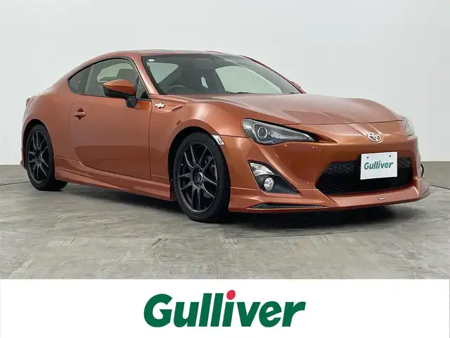 トヨタ ８６ GT 大分県 2012(平24)年 8.4万km オレンジメタリック 社外メモリーナビ/ (BT/CD/DVD/AM/FM)/プッシュスタート/ETC/革巻きステアリング/パドルシフト/純正フロアマット/電動格納ミラー/社外エアロ/ (フロント/リア）/サイドマーカー/セミバケットシート/社外18インチAW/スマートキー/保証書/取扱説明書