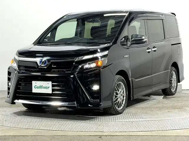 トヨタ ヴォクシー ハイブリッド ZS 煌Ⅱ 大阪府 2019(平31)年 2.2万km ブラック 純正10incナビTV バックカメラ シートヒーター クルーズコントロール 衝突軽減ブレーキ レーンアシスト オートハイビーム 両側パワースライドドア リアオートエアコン ドライブレコーダー ETC