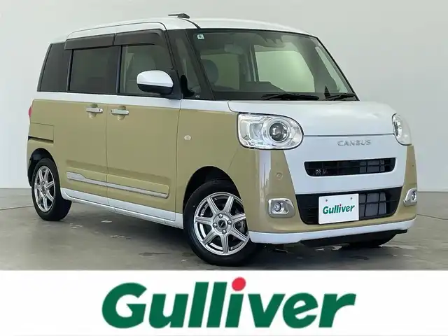ダイハツ ムーヴ キャンバス ストライプス G 富山県 2022(令4)年 0.9万km シャイニングホワイトパール/サンドベージュメタリック 社外ナビ（AM/FM/DVD/BT/フルセグ）/バックカメラ/両側パワースライドドア/シートヒーター/衝突被害軽減システム/コーナーセンサー/横滑り防止装置/アイドリングストップ/オートLEDライト/フォグライト/社外アルミホイール/純正フロアマット/オートホールド付電子パーキング/ステアリングスイッチ/スマートキー/スペアキー