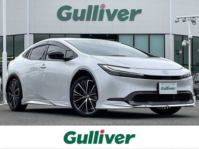 トヨタ プリウス Z 佐賀県 2023(令5)年 4.4万km プラチナホワイトパールマイカ モデリスタエアロ/純正12.3インチディスプレイオーディオ(ナビ機能・前後ドライブレコーダー機能付)/・フルセグTV/AM/FM/USB/Bluetooth/パノラミックビューモニター/ビルトインETC2.0/アドバンストパーク/デジタルインナーミラー/パワーバックドア(予約ロック機能付)/100V電源/電子パーキングブレーキ/・AUTO HOLD機能/置くだけ充電/黒レザーシート(合皮)/D席メモリー機能付パワーシート/DN席シートヒーター/シートベンチレーション/ISOFIX対応/革巻きステアリング/ステアリングヒーター/ステアリングリモコン/純正19インチアルミホイール/純正LEDヘッドライト/・オートマチックハイビーム/純正フロアマット/純正ドアバイザ―/新車保証書/取扱説明書/スペアキー１本/トヨタセーフティセンス/・レーダークルーズコントロール/・レーンディパーチャーアラート/・プリクラッシュセーフティ/・ブラインドスポットモニター/・クリアランスソナー/・リヤクロストラフィックアラート/・プロアクティブドライビングアシスト/・安心降車アシスト