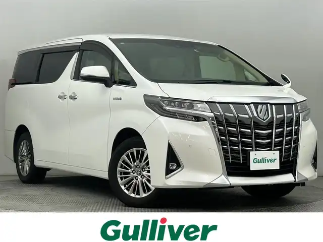 トヨタ アルファードハイブリット G 道央・札幌 2018(平30)年 6.5万km ホワイトパールクリスタルシャイン ・４ＷＤ/・フリップダウン/・純正ナビ/・BT/CD/DVD/SD/・フルセグTV/・トヨタセーフティセンス/・ビルトインETC2.0/・MTモード/・パワーシート/・両側パワースライドドア/・シートヒーター／エアコン/・純正ドライブレコーダー/・アダプティブクルーズコントロール/・ステアリングスイッチ/・電子パーキングブレーキ/・オートホールド/・オートライト/・オートマチックハイビーム/・純正フロアマット/・スマートキー/・プッシュスタート/・ホワイトレザーシート