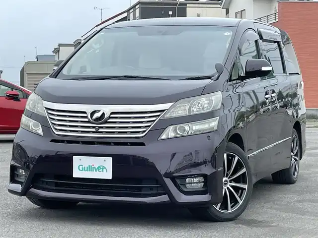 トヨタ ヴェルファイア 3．5Z Gエディション 道央・札幌 2008(平20)年 12.8万km ボルドーマイカメタリック ４WD/純正ディーラーOPナビ/CD/DVD/MD/フルセグ/純正フリップダウンモニター/横滑り防止装置/クルーズコントロール/パーキングセンサー/クリアランスソナー/AFS/センターデフロック/バック/サイド/フロントカメラ/ビルトインETC/両側パワースライドドア/パワーバックドア/前席/２列目パワーシート/D席メモリーシート/N席/２列目オットマン/革巻きウッドコンビステアリング/ステアリングリモコン/AC100V/POLEAUTO/MTモード付AT/レーダー探知機/プッシュスタート/スマートキー/HIDヘッドライト/オートライト/フォグランプ/電動格納ミラー/ウィンカーミラー/フロアマット/ドアバイザー