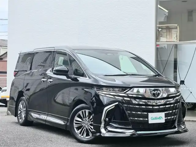 トヨタ アルファードハイブリット Z 愛知県 2024(令6)年 1.4万km ブラック /禁煙車/4WD//純正14インチディスプレイオーディオ【ナビキッドあり】/フルセグ・Bluetooth・USB・Miracast・FM・AM・交通情報//13.2型有機EL後席ディスプレイ【V13T-R72F】//パノラミックビューモニター/バックカメラ//両側パワースライドドア//モデリスタエアロ【フロント・サイド・リアアンダー】//左右独立ムーンルーフ//電動サイドシェード//前席パワーシート/メモリシート//1.2列目シートヒーター/エアシート//パワーバックドア//デジタルインナーミラー//AC100V//Toyota Safety Sense/プリクラッシュセーフティ/レーダークルーズコントロール/レーンディパーチャーアラート/レーンチェンジアラート/ロードサインアシスト/フロントクロストラフィックアラート/オートマチックハイビーム//トヨタチームメイト/アドバンストドライブ/アドバンストパーキング/ブラインドスポッドモニター/安心降車アシスト//三眼LEDオートライト//純正18インチアルミホイール//電子パーキングブレーキ//ブレーキホールド//置くだけ充電//モデリスタマフラー//プッシュスタート//ドラレコ【Y-3100】//ビルトインETC 2.0//スペアキー1本//新車保証書