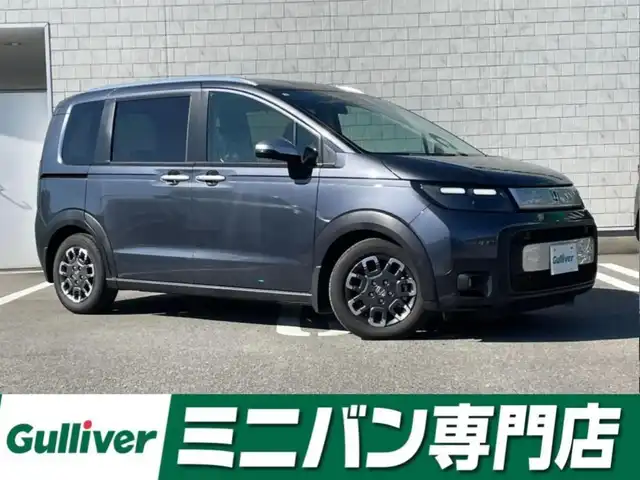 ホンダ フリード ハイブリット e:HEV クロスター 福岡県 2025(令7)年 0.7万km メテオロイドグレーメタリック 純正9型ディスプレイナビ（フルセグTV/BT）バックカメラホンダセンシングコーナーセンサーレーダークルコン両側パワスラ前後ドラレコETCBSMシートヒーター純正LEDヘッドライト純正15インチアルミホイールスマートキープッシュスタート