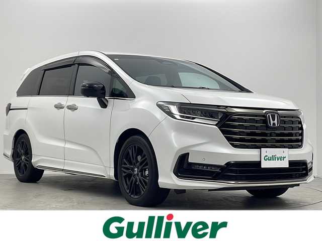 ホンダ オデッセイ ハイブリッド e:HEVアブソルート EXブラックED 大阪府 2023(令5)年 1.9万km プラチナホワイトパール 純正11インチナビ/【フルセグＴＶ/ＡＭ/ＦＭ/ＣＤ/ＤＶＤ/ＢＴ/ＵＳＢ/ＨＤＭＩ//ＡｐｐｌｅＣａｒＰｌａｙ/ＡｎｄｒｏｉｄＡｕｔｏ】/純正ドライブレコーダー前後/ETC/バックカメラ(全方位)/Honda SENSING/・衝突軽減ブレーキ/・誤発進抑制機能/・後方誤発進抑制機能/・近距離衝突軽減ブレーキ/・歩行者事故低減ステアリング/・路外逸脱抑制機能/・追従機能付きアダプティブクルーズコントロール/・車線維持支援システム/・先行車発進お知らせ機能/・標識認識機能/・オートハイビーム/・ブラインドスポットインフォメーション/・パーキングセンサーシステム/・後退出庫サポート/パワーシート(D席・N席・2列目)/シートヒーター(D席・N席・２列目)/オットマン(2列目)/両側パワースライドドア/パワーバックドア/純正フロアマット/スマートキー