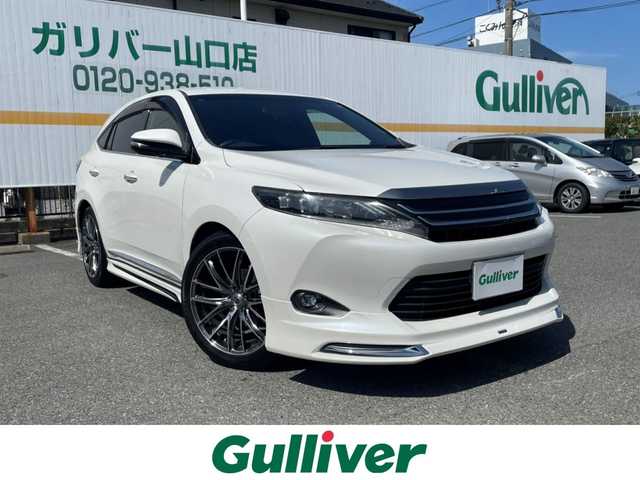トヨタ ハリアー エレガンス 山口県 2015(平27)年 8.3万km ホワイトパールクリスタルシャイン ワンオーナー/純正ナビ/　DVD/BD/CD/SD/MSV/BT/USB/AUX/フルセグTV/バックカメラ/JBLサウンド/純正LEDヘッドライト/純正フォグランプ/オートライト/社外20インチアルミホイール（RAYS）/ダウンサス(純正あり)/モデリスタエアロ/社外グリル（純正あり)/ハーフレザーシート/右前席パワーシート/革巻きステアリング/ステアリングスイッチ/横滑り防止/アイドリングストップ/スマートキー×２/ビルトインETC/純正フロアマット/純正ドアバイザー/電動格納ウインカードアミラー(オート機能付き)