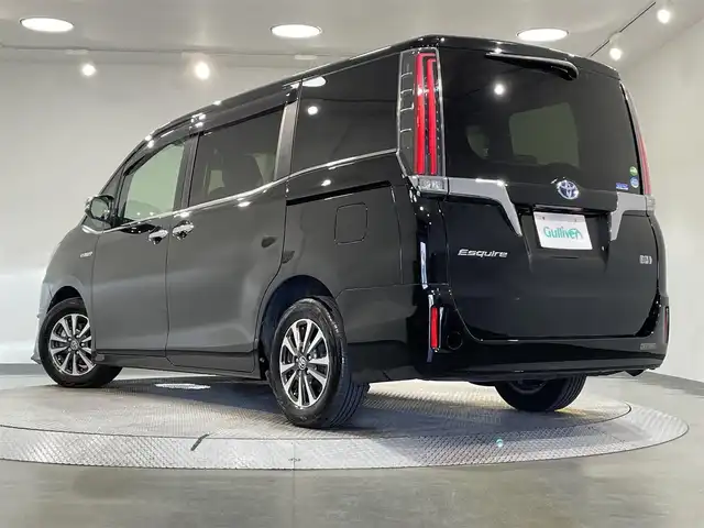 トヨタ エスクァイア ハイブリッド Gi プレミアムパッケージ 愛知県 2018(平30)年 3.4万km ブラック 純正9インチナビ（Bluetooth/フルセグTV/SD/AM/FM/CD/DVD）/純正12.1インチフリップダウンモニター/純正モデリスタフロントエアロ/トヨタセーフティセンス/被害軽減システム/両側パワースライドドア/ビルトインETC/LEDヘッドライト/シートヒーター/ステアリングヒーター/レーンキープアシスト/クルーズコントロール/バックカメラ/USB接続/プッシュスタート/スマートキー/スペアキー/純正フロアマット/純正15インチアルミホイール/ハーフレザーシート/ドアバイザー