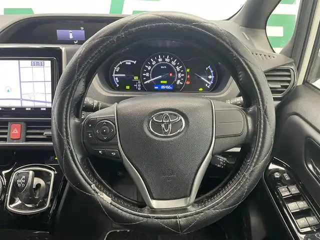 トヨタ ノア ハイブリッド Si ダブルバイビー 鹿児島県 2018(平30)年 8.6万km ホワイトパールクリスタルシャイン 禁煙車/トヨタセーフティセンスC/　・プリクラッシュセーフティ/　・レーンディバーチャーアラート/　・オートマチックハイビーム/先行車発進告知機能/クルーズコントロール(追従走行無し)/純正9型ナビ/　・Bluetooth/　・フルセグTV/　・CD/DVD/　・AM/FM/純正後席モニター/両側パワースライドドア/ETC/モデリスタエアロ/全席オートパワーウィンドウ/純正フロアマット/電動格納ミラー/ステアリングリモコン