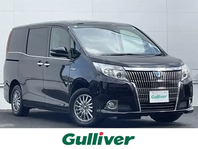 トヨタ エスクァイア ハイブリッド Xi 佐賀県 2017(平29)年 4.8万km スパークリングブラックパールクリスタルシャイン トヨタセーフティセンスC/・プリクラッシュセーフティ/・レーンディパーチャーアラート/・オートマチックハイビーム/純正10インチSDナビ/・バックカメラ/・フルセグTV/BT/CD/DVD/TVキャンセラー/純正フリップダウンモニター/社外ドラレコ(SDなし)/両側パワースライドドア/純正15インチAW/LEDヘッドライト/シートヒーター/プッシュスタート/革巻きステアリング/ETC2.0/スペアキー×2/取扱説明書/保証書