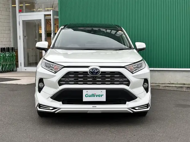 トヨタ ＲＡＶ４ ハイブリッドG 宮城県 2021(令3)年 4.3万km ホワイトパールクリスタルシャイン パノラマムーンルーフ/デジタルインナーミラー/＝＝＝/モデリスタエアロ（F/S/R）/セーフティセンス/・プリクラッシュセーフティ/・レーントレーシングアシスト/・レーダークルーズコントロール/・オートマチックハイビーム/・ロードサインアシスト/先行車発進告知/インテリジェントクリアランスソナー/リアクロストラフィックオートブレーキ/ブラインドスポットモニター/9インチディスプレイオーディオ/・ナビ機能付/・Bluetooth/・フルセグTV/・AppleCarPlay/AndroidAuto/パノラミックビューモニター/ビルトインETC2.0/ドライブレコーダー/AC100V/1500W/ハンズフリーパワーバックドア/合皮シート/運転席メモリー機能付パワーシート/前席シートヒーター/革巻きステアリング/ステアリングヒーター/電動パーキングブレーキ/ブレーキホールド/LEDヘッドランプ/フォグランプ/オートライト/スマートキー＆プッシュスタート/電動格納ミラー/純正18インチAW/純正フロアマット/純正ドアバイザー