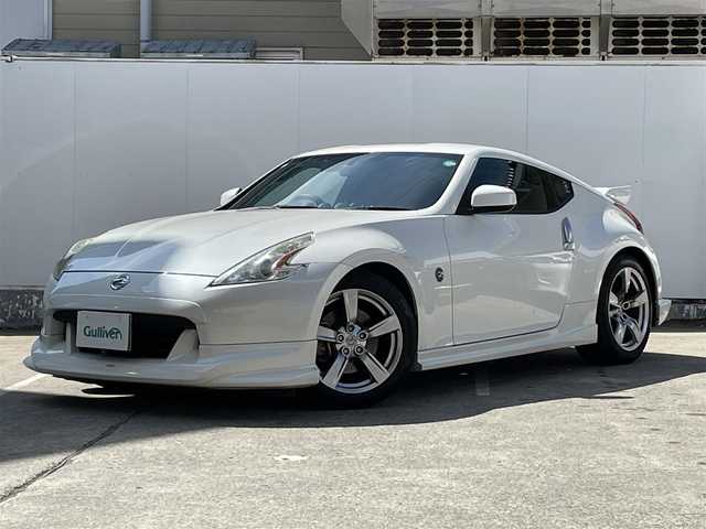 日産 フェアレディ Ｚ バージョンT 青森県 2009(平21)年 9.3万km ブリリアントホワイトパール 純正メモリナビ/AM/FM/CD/DVD/AUX/NISMOエアロ/V6ツインターボ/柿本マフラー/バックカメラ/社外ドライブレコーダー/シートヒーター/ハーフレザーシート/パドルシフト/純正フロアマット/スペアキー/純正AWサマータイヤ/取扱説明書/保証書