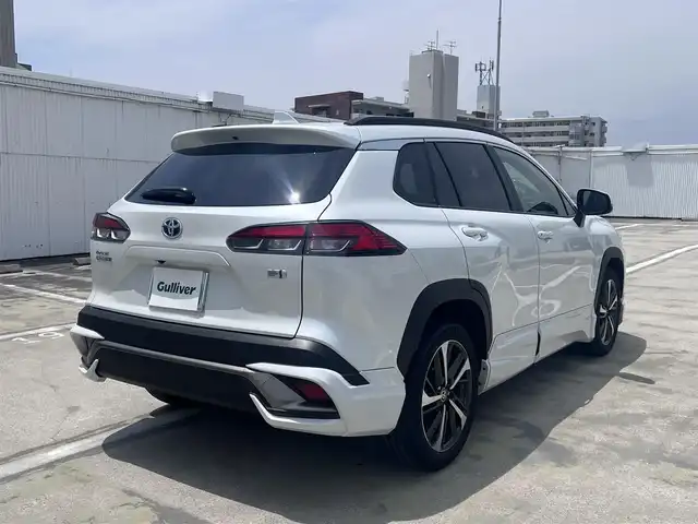 トヨタ カローラ クロス ハイブリッド Z 広島県 2023(令5)年 2.3万km プラチナホワイトパールマイカ ○走行距離：22468km（入庫時）/ワンオーナー/純正9インチディスプレイ・ナビ/フルセグTV・パノラミックビュー/ブラインドスポットモニター/ガラスルーフ/モデリスタエアロ/パワーバックドア/フロントシートヒーター/パワーシート/セーフティセンス/LEDヘッドライト/LEDフォグライト/保証書あり/取り扱い説明書あり/スペア（スマートキー）あり