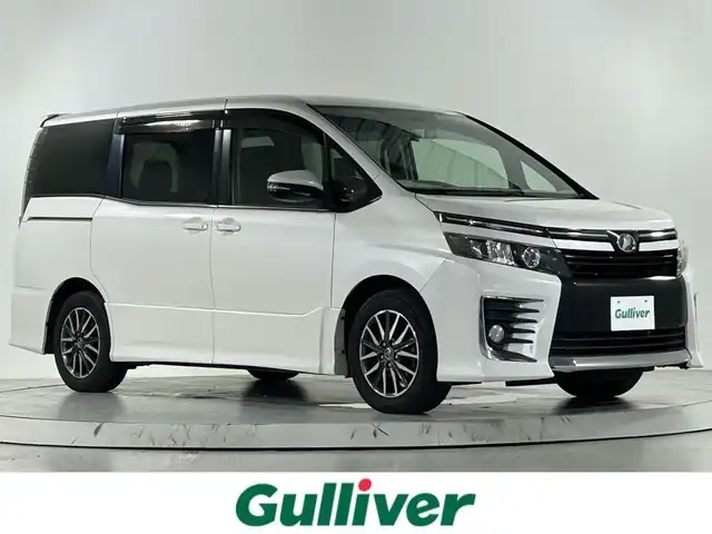 トヨタ ヴォクシー ZS 佐賀県 2014(平26)年 12万km ホワイトパールクリスタルシャイン 社外１０インチナビ/CD/DVD/フルセグTV/Bluetooth/HDMI/社外11.４インチフリップダウンモニター/両側パワースライドドア/前後ドライブレコーダー/ビルトインETC/フロアマット/ドアバイザー/サンシェード/電動格納ミラー/オートライト/LEDヘッドライト/純正１６インチアルミホイール
