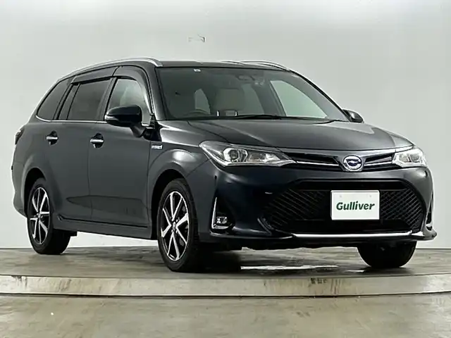 トヨタ カローラ フィールダー ハイブリッドG ダブルバイビー 愛知県 2019(平31)年 2.1万km ブラッキッシュアゲハガラスフレーク ホワイトインテリア/・ホワイト合皮シート/・ホワイト専用インパネ加飾/・ホワイト専用アームレスト/前席シートヒーター/純正7インチナビ/（ＤＶＤ/ＣＤ/フルセグ/Bluetooth/ＦＭ/ＡＭ）/セーフティセンス/・プリクラッシュセーフティ/・レーンディパーチャーアラート/・オートマチックハイビーム/バックカメラ/純正16インチアルミホイール/スマートキー/プッシュスタート/ＬＥＤライト/ナノイー/純正１６インチＡＷ/クルーズコントロール/純正フロアマット/ＥＴＣ