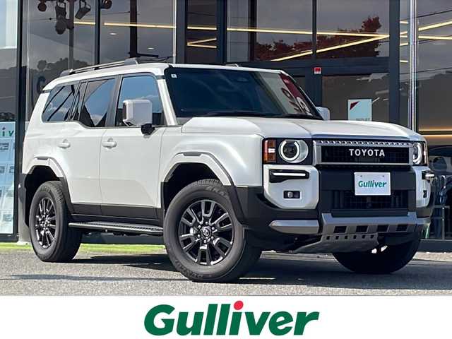 トヨタ ランドクルーザー ２５０ VX 大阪府 2024(令6)年 0.4万km プラチナホワイトパールマイカ ワンオーナー/サンルーフ/モデリスタパッケージ/モデリスタシグネチャーイルミブレード/モデリスタオーバーフェンダーホワイト/モデリスタリアスポイラー/丸目ヘッドランプ（標準角目積み込み）/純正ディスプレイオーディオ/（フルセグＴＶ・Bluetooth・USB）/パノラミックビューモニター/デジタルインナーミラー/セーフティセンス/・プリクラッシュセーフティ/・レーンディパーチャーアラート/・オートマチックハイビーム/・ドライバー異常時対応システム/・プロアクティブドライビングアシスト/・発進遅れ告知機能/・レーントレーシングアシスト/・レーダークルーズコントロール/・ロードサインアシスト/パワーバックドア/ブラインドスポットモニター/LEDヘッドライト/スマートキー/ビルトインETC2.0/D席パワーシート/黒レザーシート/前席シートヒーター/前席エアシート/リアクロストラフィックアラート/リアカメラディテクション/安心降車アシスト/車両接近サポート/横滑り防止機能/保証書/取説/スペアキー