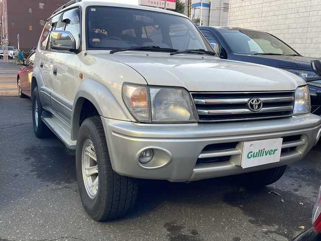 トヨタ ランドクルーザー プラド TX－LTD ワイド 道央・札幌 1999(平11)年 16.1万km ホワイトパールクリスタルシャイン 純正オーディオ（AM/FM/CD/MD）/マルチインフォメーションディスプレイ/オートエアコン/サンルーフ（手動）/バックカメラ（ミラー型）/レーダー探知機（品番ZVR-175N）/エアバッグ（前席）/車載用ロッドホルダー/3列シート/フォグランプ/セキュリティコードナビゲーション/リアヒーター/ルーフレール/パワーモード/2速スタートモード/アイドルアップ/純正フロアマット/パワーウィンドウ/電動格納ミラー