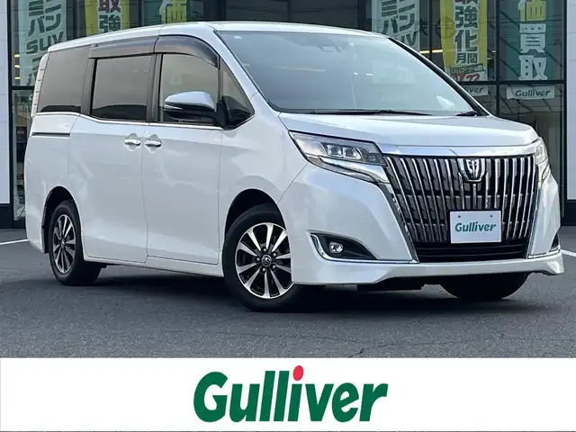トヨタ エスクァイア Gi プレミアムパッケージ 岡山県 2018(平30)年 6.8万km ホワイトパールクリスタルシャイン 登録時走行距離67842km/ワンオーナー/純正10インチナビ/フルセグTV(AM/FM/CD/DVD/Bluetooth)/純正12.1インチフリップダウンモニター/バックカメラ/両側パワースライドドア/ドライブレコーダー/ビルトインETC/トヨタセーフティセンス/・プリクラッシュセーフティ/・オートマチックハイビーム/・レーンディバーチャーアラート/クルーズコントロール/横滑り防止装置/シートヒーター/ステアリングヒーター/アイドリングストップ/１５インチ純正AW/ハーフレザーシート/LEDヘッドライト/純正フロアマット