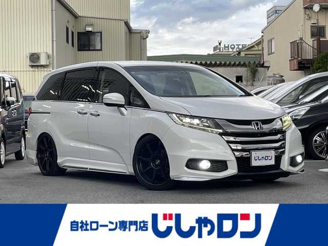ホンダ オデッセイ アブソルート EX 大阪府 2013(平25)年 11.6万km ホワイトオーキッドパール (株)IDOMが運営する【じしゃロン東大阪店】の自社ローン専用車両になりますこちらは現金またはオートローンご利用時の価格です。自社ローンご希望の方は別途その旨お申付け下さい/全方位カメラ/純正インターナビ/フルセグテレビ/BLITZダウンサス/社外マフラー/社外20インチアルミ/BLITZ GPSレーダー/パドルシフト/前方ドライブレコーダー/両側パワースライドドア/本革巻きステアリング/二列目オットマン/ビルトインETC/クルーズコントロール/後方コーナーセンサー/運転席パワーシート/AFS/衝突被害軽減システム/横滑り防止装置/盗難防止装置/純正AW付きスタッドレスタイヤ積込/スマートキー＆プッシュスタート/取説＆保証書/スペアスマートキー