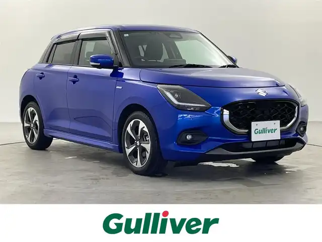 スズキ スイフト HYBRID MZ 福井県 2024(令6)年 1万km 青 純正9型メモリナビ/（CD・DVD・TV・FM・AM・Bluetooth・USB・Ipod・HDMI・AppleCArPlay・AndroidAuto）/全方位カメラ /スペアキー　/電子パーキング/純正ビルトインETC /シートヒーター /純正アルミホイール /前後センサー/LEDヘッドライト/ABS/レーンキープアシスト/横滑り防止装置/オートライト/LEDヘッドライト