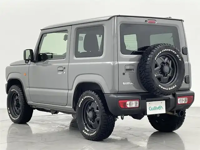 スズキ ジムニー XL 熊本県 2021(令3)年 2.3万km ミディアムグレー ワンオーナー　/禁煙車　/5速MT/ディスプレイオーディオ/バックカメラ　/社外全周囲ドラレコ　/ＥＴＣ２．０　/社外マフラー/前席シートヒーター　/ダウンヒルアシスト　/横滑り防止　/電動格納ミラー/スマートキー/プッシュスタート/スペアキー1本/保証書/取扱説明書