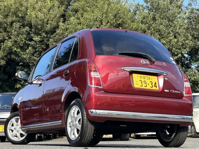 ダイハツ ミラ ジーノ プレミアムX 東京都 2008(平20)年 8.8万km ルージュレッドクリスタルメタリック フロントフォグランプ/MOMO製本木製ステアリングホイール/木目調シフトノブ/タン革/スエード調ファブリックコンビシート/carrozzeriaオーディオ（MVH-5600）/・Bluetoothオーディオ/AUX/FM/AM/ETC/取扱説明書/保証書