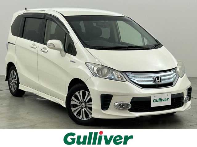 ホンダ フリード ハイブリット ジャストセレクション 福岡県 2013(平25)年 9万km プレミアムホワイトパール 社外パナソニックナビ（ＢＴ，フルセグＴＶ）　/ＥＴＣ　/前後ドライブレコーダー　/クルーズコントロール　/両側電動スライドドア　/横滑り防止装置　/フロントガラス熱線　/電動格納式ドアミラー　/純正１５インチＡＷ