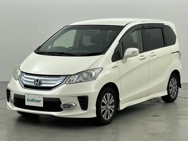 ホンダ フリード ハイブリット ジャストセレクション 福岡県 2013(平25)年 9万km プレミアムホワイトパール 社外パナソニックナビ（ＢＴ，フルセグＴＶ）　/ＥＴＣ　/前後ドライブレコーダー　/クルーズコントロール　/両側電動スライドドア　/横滑り防止装置　/フロントガラス熱線　/電動格納式ドアミラー　/純正１５インチＡＷ