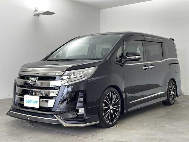 トヨタ ノア Si ダブルバイビーⅡ 兵庫県 2019(令1)年 2.3万km ブラック ・純正9インチナビ&TV&CD&DVD&BT&HDMI&SD/・純正12.1インチフリップダウンモニター/・両側パワースライドドア/・純正プレミアムサウンドシステム/・モデリスタ(フロント・サイド・リア)/・トヨタセーフティセンス/・プリクラッシュセーフティ/・レーンディパーチャーアラート/・クリアランスソナー/・オートマチックハイビーム/・LEDヘッドライト/・RAYS 18インチAW/・社外パーフェクトダンパー５Gスペシャル/・全長式車高調キット/・BRITZ スロットルコントローラー/・ルームミラー一体型レーダー探知機/・クルーズコントロール/・パーキングサポートブレーキ/・先行車発進告知/・ハーフレザーシート/・オットマン/・フォグランプ/・ビルトインETC2.0/・純正ドライブレコーダー/・プッシュスタート/・スペアキー/・ステアリングリモコン