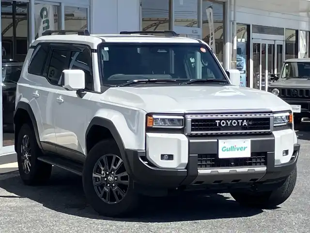 トヨタ ランドクルーザー ２５０ VX 山口県 2025(令7)年 0.5万km プラチナホワイトパールマイカ 純正ディスプレイナビ＆/パノラミックビューカメラ/＆フルセグTV/サンルーフ/黒レザーシート/純正LEDヘッドライト/純正フォグランプ/純正18インチアルミ/純正ルーフレール/オートライト/オートハイビーム/クルーズコントロール/パワーバックドア/ステリングヒーター/運転席パワーシート/フロントシートヒーター/＆シートベンチレーション