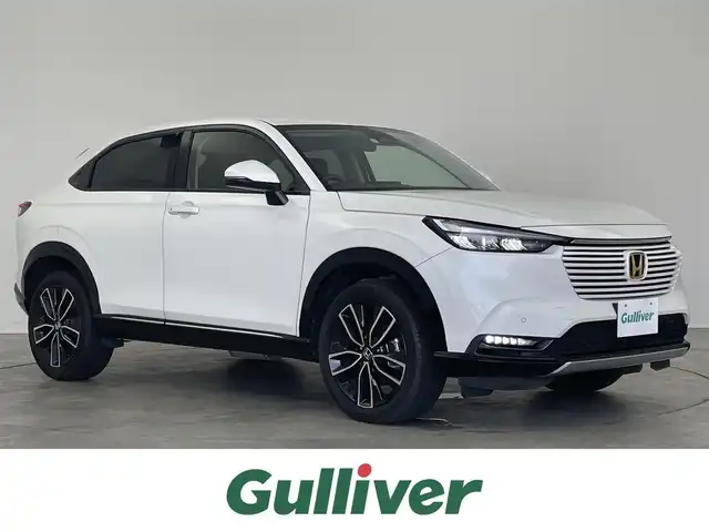 ホンダ ヴェゼル ハイブリッド e:HEV Z 埼玉県 2021(令3)年 2.5万km プラチナホワイトパール 10インチポータブルナビ/ホンダセンシング/衝突軽減ブレーキ/踏み間違い衝突軽減システム/ブラインドスポットインフォメーション/レーダークルーズコントロール/レーンキープアシスト/クリアランスソナー /オートパーキングブレーキホールド/ハーフレザー/シートヒーター/ステアリングヒーター/パドルシフト/ハンズフリーパワーバックドア/ＬＥＤオートライト/フォグランプ/スマートキー/ETC