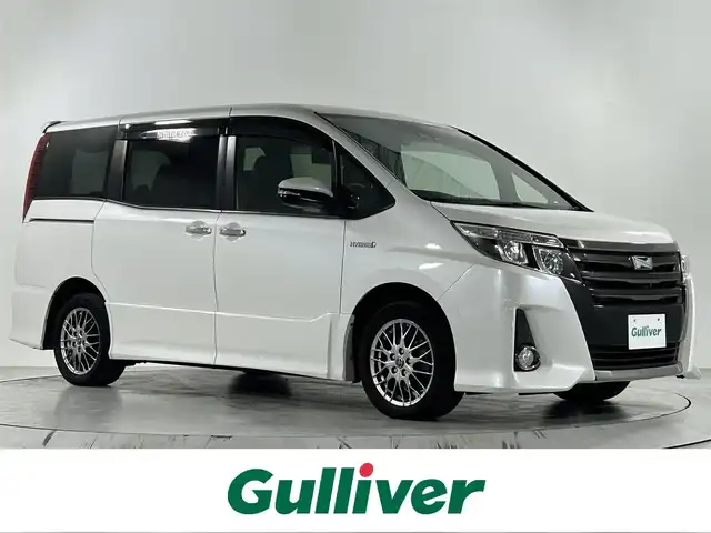 トヨタ ノア ハイブリッド Si ダブルバイビー 佐賀県 2017(平29)年 6.9万km ホワイトパールクリスタルシャイン 純正ディーラーオプション7インチナビ/バックカメラ/フルセグテレビ/CD/DVD/BT/SD/FM.AM/後席フリップダウンモニター/プリクラッシュセーフティ/レーンディパーチャーアラート/オートハイビーム/クルーズコントロール/両側パワースライドドア/ビルトインETC2.0/ステアリングスイッチ/ハーフレザーシート