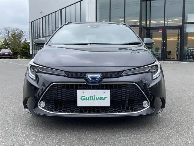トヨタ カローラツーリング ハイブリッド ダブルバイビー 青森県 2021(令3)年 1.9万km スパークリングブラックパールクリスタルシャイン ・ワンオーナー/・４ＷＤ/・純正ＳＤナビ/　AM/FM/DVD/CD/USB/Bluetooth/・フルセグＴＶ/・バックカメラ/・ビルトインＥＴＣ/・セーフティセンス（予防安全パッケージ）/・プリクラッシュセーフティ/・レーントレーシングアシスト/・全車速追従機能付レーダークルーズコントロール/・オートマチックハイビーム/・ロードサインアシスト/・ドライブスタートコントロール/・車両接近通報装置/・フォグランプ/・ドアバイザー/・純正フロアマット/・１７インチ夏タイヤ純正アルミホイール装着/・スペアキー/・取扱説明書