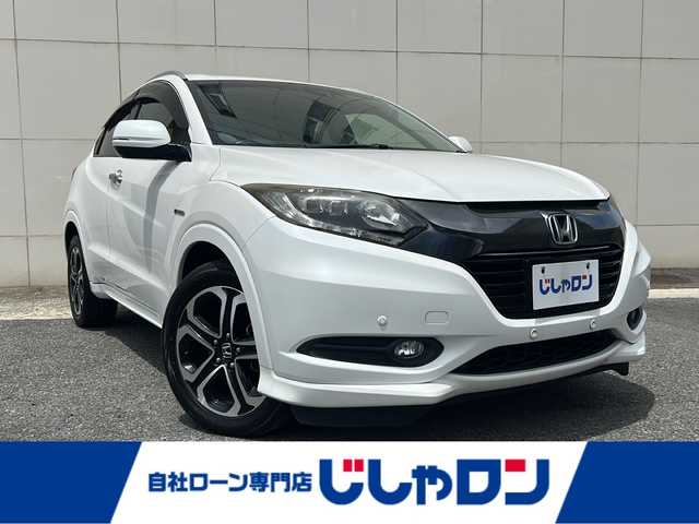 ホンダ ヴェゼル ハイブリッド Z 埼玉県 2015(平27)年 13.8万km ホワイトオーキッドパール (株)IDOMが運営する【じしゃロン熊谷店】の自社ローン専用車両になりますこちらは現金またはオートローンご利用時の価格です。自社ローンご希望の方は別途その旨お申付け下さい/純正HDDナビ（BT/フルセグTV/AM/FM/CD/DVD)/ETC/社外ドライブレコーダー/バックカメラ/クルーズコントロール/LEDヘッドライト/コーナーセンサー/スペアキー/ルーフレール/シートヒーター/純正アルミホイール/プッシュスタート/純正フロアマット/ECON