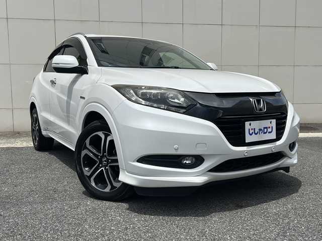 ホンダ ヴェゼル ハイブリッド Z 埼玉県 2015(平27)年 13.8万km ホワイトオーキッドパール (株)IDOMが運営する【じしゃロン熊谷店】の自社ローン専用車両になりますこちらは現金またはオートローンご利用時の価格です。自社ローンご希望の方は別途その旨お申付け下さい/純正HDDナビ（BT/フルセグTV/AM/FM/CD/DVD)/ETC/社外ドライブレコーダー/バックカメラ/クルーズコントロール/LEDヘッドライト/コーナーセンサー/スペアキー/ルーフレール/シートヒーター/純正アルミホイール/プッシュスタート/純正フロアマット/ECON