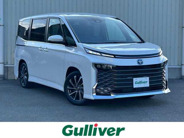 トヨタ ヴォクシー ハイブリッド S－Z 山形県 2025(令7)年 0.1万km未満 ホワイトパールクリスタルシャイン 純正HDDナビ/(フルセグTV/Bluetooth/USB/HDMI)/フリップダウンモニター/両側パワースライドドア/クルーズコントロール/バックカメラ/ETC2.0/シートヒーター/ハンドルヒーター/純正LEDライト/純正アルミホイール/ハーフレザーシート
