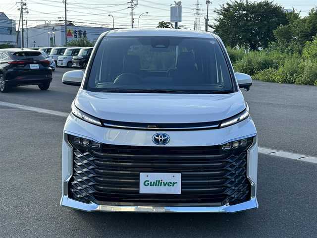 トヨタ ヴォクシー ハイブリッド S－Z 山形県 2025(令7)年 0.1万km未満 ホワイトパールクリスタルシャイン 純正HDDナビ/(フルセグTV/Bluetooth/USB/HDMI)/フリップダウンモニター/両側パワースライドドア/クルーズコントロール/バックカメラ/ETC2.0/シートヒーター/ハンドルヒーター/純正LEDライト/純正アルミホイール/ハーフレザーシート