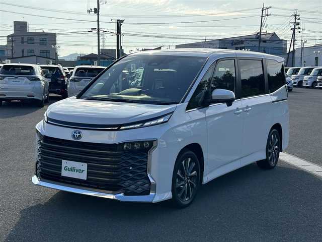 トヨタ ヴォクシー ハイブリッド S－Z 山形県 2025(令7)年 0.1万km未満 ホワイトパールクリスタルシャイン 純正HDDナビ/(フルセグTV/Bluetooth/USB/HDMI)/フリップダウンモニター/両側パワースライドドア/クルーズコントロール/バックカメラ/ETC2.0/シートヒーター/ハンドルヒーター/純正LEDライト/純正アルミホイール/ハーフレザーシート