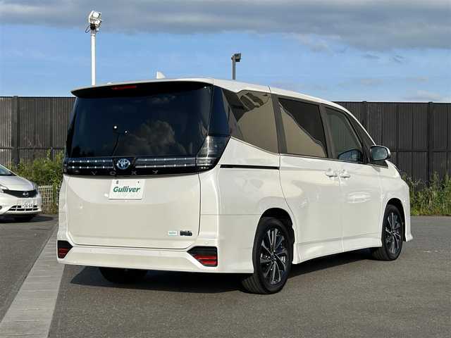 トヨタ ヴォクシー ハイブリッド S－Z 山形県 2025(令7)年 0.1万km未満 ホワイトパールクリスタルシャイン 純正HDDナビ/(フルセグTV/Bluetooth/USB/HDMI)/フリップダウンモニター/両側パワースライドドア/クルーズコントロール/バックカメラ/ETC2.0/シートヒーター/ハンドルヒーター/純正LEDライト/純正アルミホイール/ハーフレザーシート