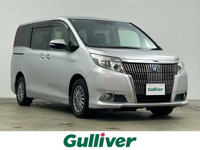 トヨタ エスクァイア ハイブリッド Gi 千葉県 2016(平28)年 6万km シルバーM 禁煙車/トヨタセーフティセンス/・先行車発進システム/・レーンディパーチャーアラート/・クルーズコントロール/両側電動ドア/純正９インチメモリナビ/・型番：NSZT-Y66T/・CD/DVD/Bluetooth/フルセグTV/・バックカメラ/・ビルトインETC/革巻きステアリング/・ステアリングスイッチ/レザーシート/・DNシートヒーター/左右独立エアコン/純正フロアマット/純正１５インチAW/オートライト/・オートマチックハイビーム/・LEDヘッドライト/・LEDフォグランプ