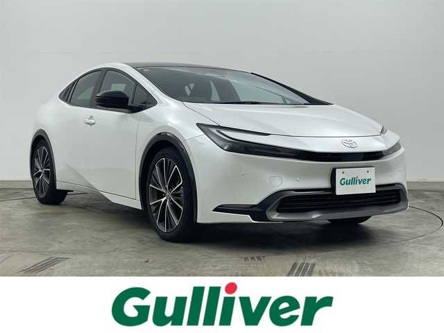 トヨタ プリウス Z 岡山県 2024(令6)年 1.6万km プラチナホワイトパールマイカ ワンオーナー/パノラマルーフ/純正12.3インチディスプレイオーディオ	/【ナビ/フルセグ/Bluetooth/Carplay/HDMI】	/パノラミックビューモニター/追従型クルーズコントロール/ブラインドスポットモニター/オートブレーキホールド	/寒冷地仕様/オートハイビーム	/LEDヘッドライト（AUTO機能付き）	/ビルトインETC２．０/前席シートヒーター/ステアリングヒーター/前席エアシート	/運転席パワーシート	/衝突軽減ブレーキシステム	/車線逸脱防止システム	/横滑り防止装置/踏み間違い防止	/純正19インチアルミ	/コーナーセンサー（前後）	/純正フロアマット	/レッドフィルムインパネ加飾/レッド加飾付合皮スポーティーシート/ステアリングスイッチ	/チルトステアリング/シートリフター/ウィンカーミラー/プッシュスタート	/ワイヤレス充電