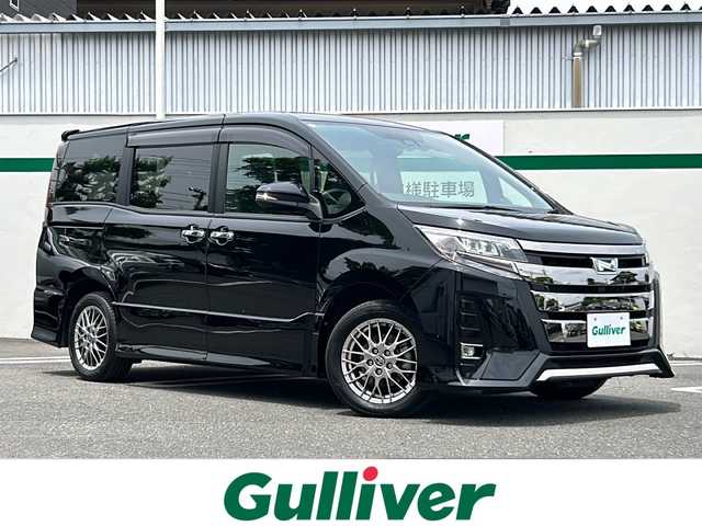 トヨタ ノア ハイブリッド Si ダブルバイビーⅡ 東京都 2020(令2)年 3.1万km ブラック ワンオーナー/Toyota Safety Sense/・PCS(プリクラッシュセーフティー)/・LDA(レーンディパーチャアラー)/・オートマチックハイビーム/・先行車発進告知機能/クルーズコントロール/クリアランスソナー/TOYOTA純正１０インチナビ/【フルセグ・Bluetooth】/フリップダウンモニター/バックカメラ/前方ドライブレコーダー/両側パワースライドドア/シートヒーター（運転席・助手席）/純正16インチアルミ/純正フロアマット/スマートキー/スペアキー/保証書/取説