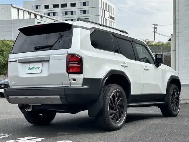 トヨタ ランドクルーザー ２５０ VX 長崎県 2024(令6)年 0.3万km プラチナホワイトパールマイカ ワンオーナー/純正ディスプレイオーディオ/(FM/AM/BT/フルセグTV/Miracast/ナビ)/プッシュスタート/MTモード付AT/フルタイム4WD/ビルトインETC/全方位カメラ/サンルーフ/ルーフレール/レーダークルーズコントロール/ドライブレコーダー内蔵型デジタルインナーミラー/純正フロアマット/モデリスタR20アルミホイール/ステアリングヒーター/レザーシート/D席パワーシート/DN席シートヒーター/DN席エアシート/3列シート/パワーバックドア/オートライト/オートハイビーム/ABS/TRC/VSC/LDA/BSM/PCS/PDA/RCTA/RCD/RSA/クリアランスソナー/SRSダブルエアバッグ/SRSサイドエアバッグ/スマートキー/スペアキー/取扱説明書/保証書